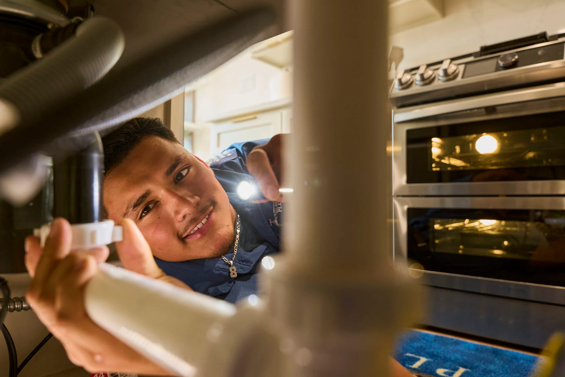 Skilled plumber inspecting a clogged drain in University Park, TX